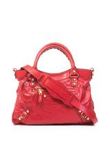 Balenciaga Balenciaga’s Giant Town bag has become a covetable investment piece since its inception just over a decade ago. This bright post box-red leather edition with signature gold hardware will carry you from season to season.
